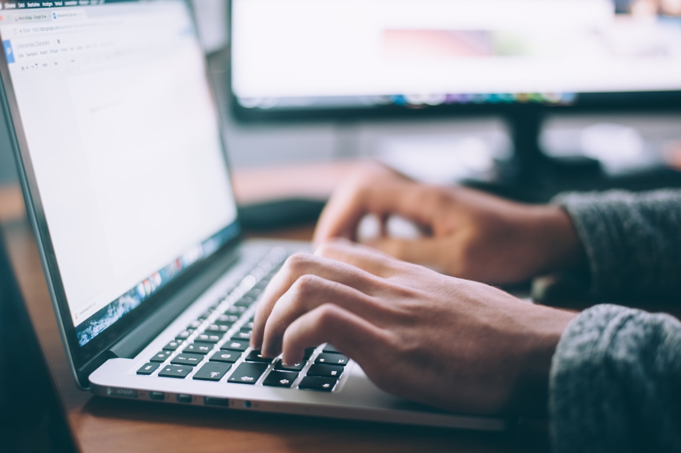 Laptop open on a wooden desk for ecommerce work