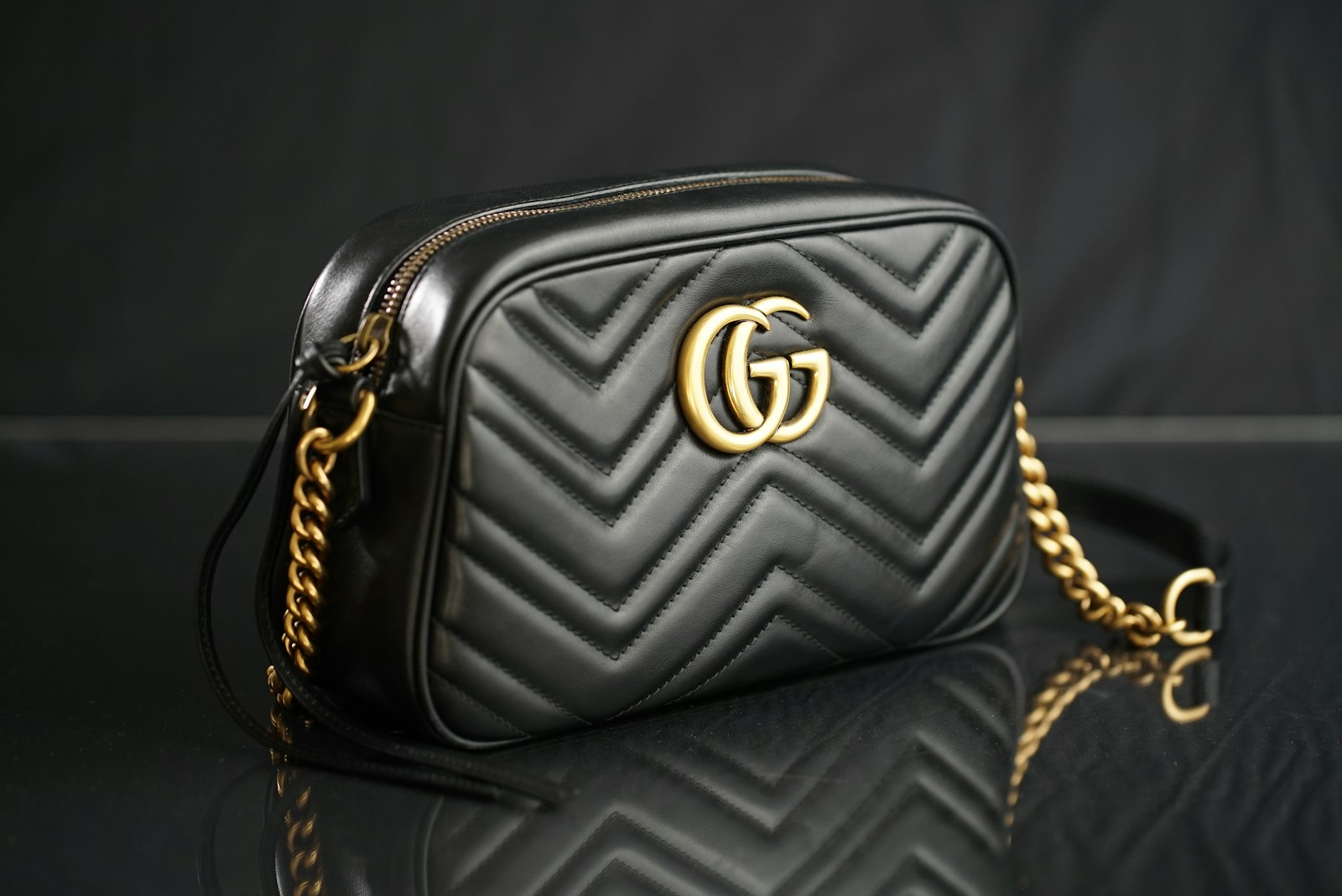Close-up leather grain and stitching on a handbag for AI product video QA